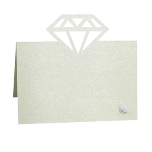 Macro shot of white pearlescent place card featuring intricate laser-cut diamond pattern