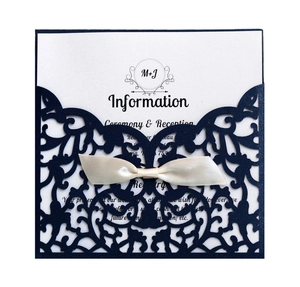 Navy blue laser cut wedding invitation with cream satin ribbon and elegant paper insert