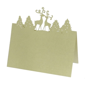 Laser-cut reindeer and pine tree silhouette on green Christmas name place card