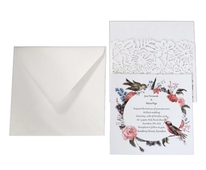 Detail of laser-cut floral invitation sleeve with rose print insert and square envelope