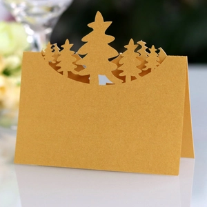 Laser-cut gold Christmas tree place card with pearl finish for festive table setting