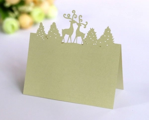 Detailed laser-cut forest deer place card in sage green for wedding table decor