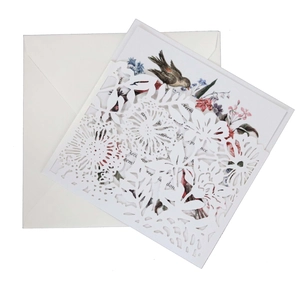 Detail of laser-cut floral lavender invitation with elegant painted flower and bird insert