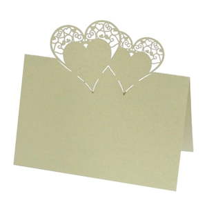 Detailed laser-cut heart hollow place card in champagne gold pearlescent paper finish