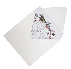 Detail of laser-cut lavender floral wedding invitation with bird illustration and envelope