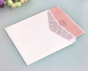 Elegant laser cut lace wedding invitation with white hollow envelope and pink card