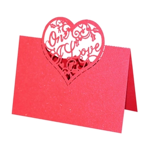 Detail of red glitter card featuring laser-cut heart shape and One Love design