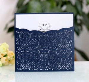 Detail of laser-cut navy blue floral invitation sleeve with premium pearlescent finish