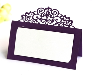 Macro detail of laser-cut lace place card in purple for wedding and event seating