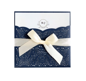 Elegant navy blue laser cut wedding invitation card with ivory ribbon bow and MJ monogram