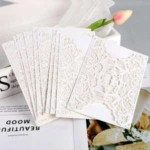 Laser cut white rose invitations featuring elegant hollow floral lace details on cardstock