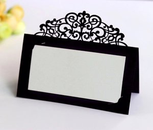 Macro detail of black laser-cut lace place card with blank insert for weddings