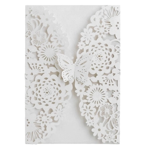 Elegant white laser-cut wedding invitation featuring intricate floral and butterfly patterns