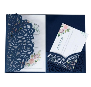Detail of laser-cut rose hollow pocket in navy blue with floral insert and RSVP card