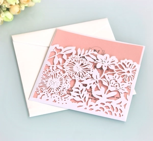 Detail of laser-cut lavender floral wedding invitation set with pearlized paper finish