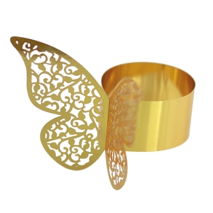 Detailed view of laser-cut gold butterfly napkin ring with elegant hollow patterns