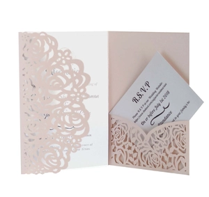 Detail of laser-cut rose hollow invitation kit with soft pink outer shell and white RSVP card