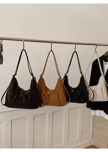 Detail of minimalist crossbody bags with drawstring front pockets in four colors