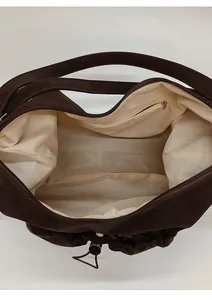 Detail view of large capacity bag interior with zipper pocket and beige lining fabric