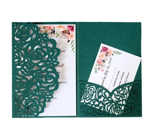 Detail of laser-cut rose hollow design on dark green wedding invitation card set