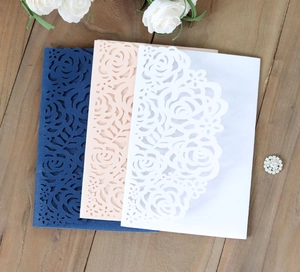 Laser-cut hollow rose wedding invitations in navy blue, pink and white pearlescent paper