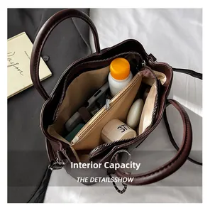 Top view of deep brown bucket bag interior showing large capacity and multi-compartment design