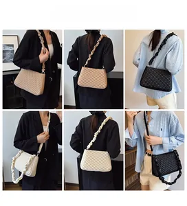 Detail view of quilted crossbody bag showing thick pleated and slim shoulder straps