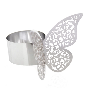 Macro detail of silver mirror finish butterfly napkin ring with laser-cut vine patterns