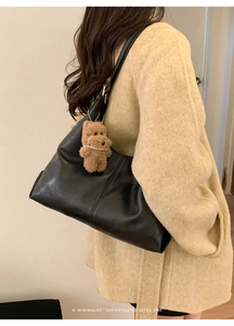 Minimalist black retro shoulder bag with cute brown plush bear charm and pearl detail