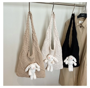Detailed view of textured knit tote bags featuring cute plush bunny dolls on three colors