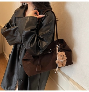 Deep brown suede tote bag with metal buckle detail and cute plush bear charm