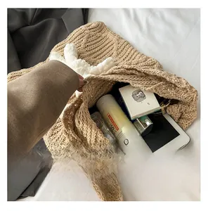 Macro shot of khaki knit tote bag showing spacious interior for tablet and daily items