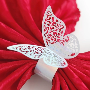 Macro view of white iridescent butterfly napkin ring with laser-cut filigree pattern