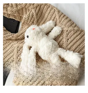 Close-up of white plush rabbit toy with soft long fur and cute facial details