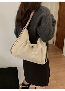 Minimalist beige suede tote bag shown on model for daily sophisticated shoulder wear style