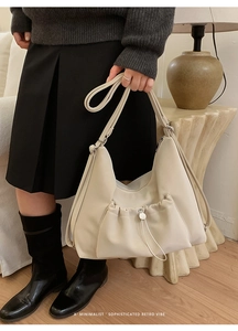 Minimalist retro cream tote bag with drawstring pocket detail shown in a cozy home setting