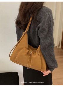 Sophisticated retro mustard yellow tote bag with drawstring pocket detail on model