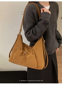 Detail of vintage mustard yellow suede tote bag featuring a drawstring front pocket