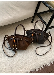 Detail of retro mini bucket bags with colorful wooden beads and adjustable straps