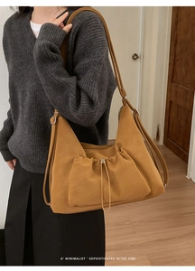 Detail of ginger yellow matte tote bag with drawstring design and adjustable strap