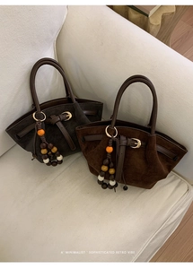 Detail of retro tote bags in brown suede and printed textures with beaded charms