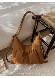 Detail of tan faux suede versatile backpack showing the soft texture and drawstring pocket