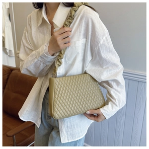Close-up of olive green quilted hobo bag with unique ruched cloud handle detail