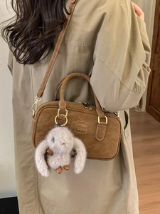 Brown suede bowling bag with dual handles and long shoulder strap for women