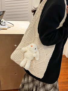 Cute rabbit plush doll on cream knit tote bag with diamond pattern for autumn and winter