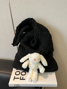 Chic black cable knit tote bag featuring a cute white plush bunny doll for women