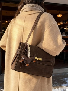 Fashionable dark brown suede tote bag with golden twist lock and dog pendant