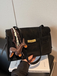 Classic black leather tote bag with gold buckle and a decorative horse charm