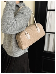 Détail du sac à bandoulière en polaire beige avec poignée en cuir et zip métallique