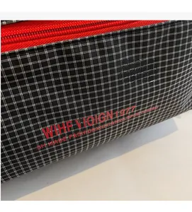 Detail of checkered pencil case with red zipper and WIHF VIOIGN 1977 typography
